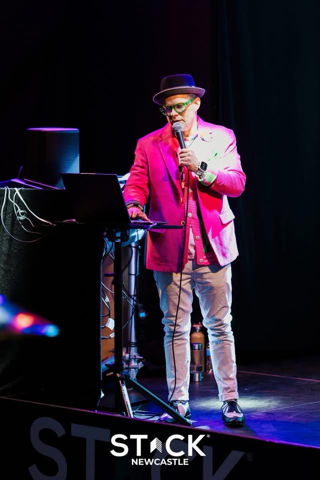 Christian Steel hosting the quiz on stage at Stack Newcastle, mic in hand